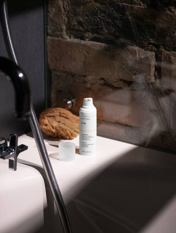 White bottle on a bathroom counter with a stone wall background